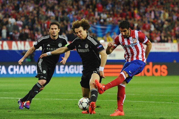 MADRID, SPAIN - APRIL 22:  Raul Garcia of Club Atletico de Madrid is tackled by David Luiz of Chelsea during the UEFA Champions League Semi Final first leg match between Club Atletico de Madrid and Chelsea at Vicente Calderon Stadium on April 22, 2014 in Madrid, Spain.  (Photo by Mike Hewitt/Getty Images)