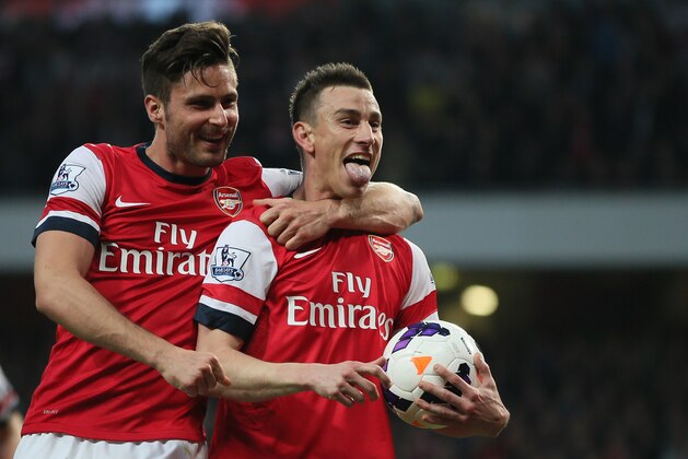 Arsenal's Laurent Koscielny, right, celebrates with teammate Oliver Giroud after scoring the opening goal during their English Premier League soccer match between Arsenal and Newcastle United at the Emirates stadium in London, Monday, April 28,  2014. (AP Photo/Alastair Grant)