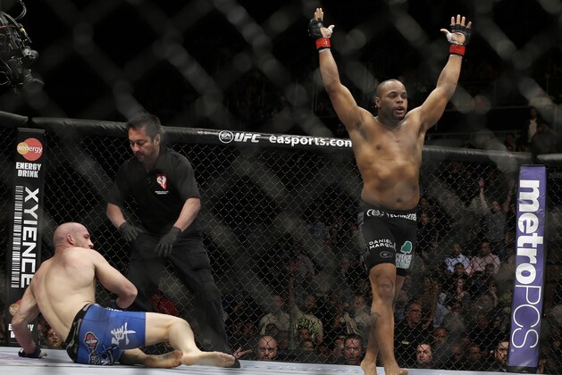 Daniel Cormier, right, reacts as the referee stops his UFC 170 mixed martial arts light heavyweight fight against Patrick Cummins on Saturday, Feb. 22, 2014, in Las Vegas. (AP Photo/Isaac Brekken)