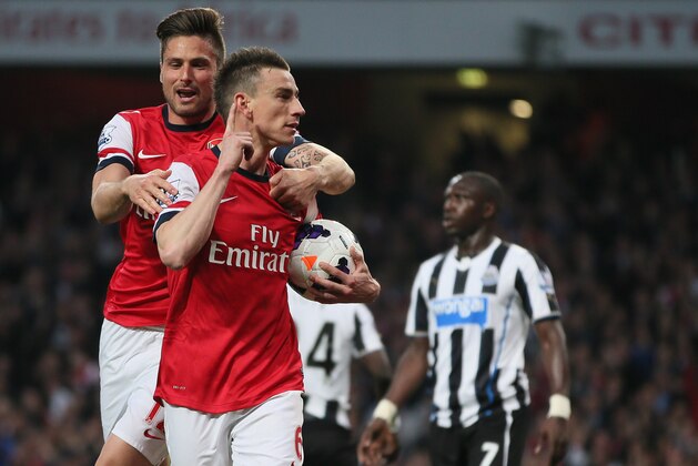 Arsenal's Laurent Koscielny, right, celebrates with teammate Oliver Giroud after scoring the opening goal during their English Premier League soccer match between Arsenal and Newcastle United at the Emirates stadium in London, Monday, April 28, 2014. (AP Photo/Alastair Grant) Arsenal's Laurent Koscielny, right, celebrates with teammate Oliver Giroud after scoring the opening goal during their English Premier League soccer match between Arsenal and Newcastle United at the Emirates stadium in London, Monday, April 28, 2014. (AP Photo/Alastair Grant)