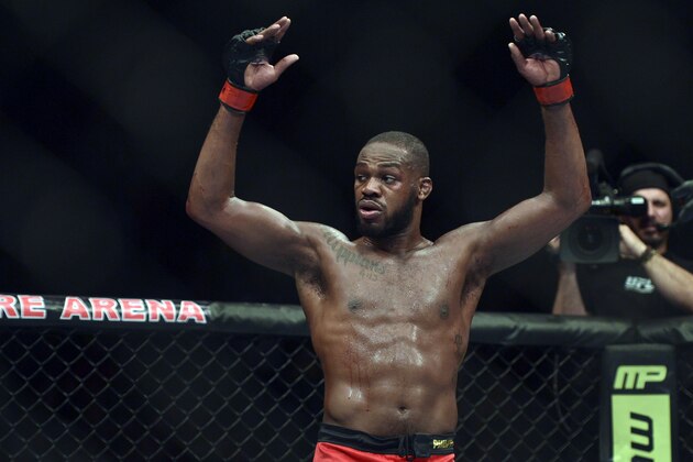 Apr 26, 2014; Baltimore, MD, USA;  Jon Jones puts his arms in the air after the UFC light heavy weight championship fight against Glover Texeira at  Baltimore Arena. Jones retained the light heavy height championship by defeating  Teixeria.  Mandatory Credit: Tommy Gilligan-USA TODAY Sports