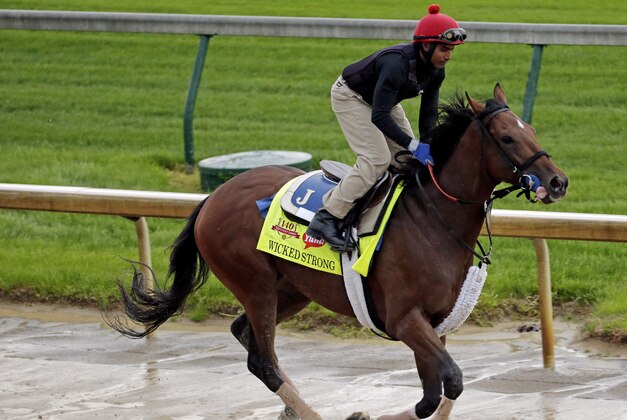 Exercise rider Kelvin Pahal takes Kentucky Derby hopeful Wicked Strong for a morning workout at Churchill Downs Monday, April 28, 2014, in Louisville, Ky. (AP Photo/Charlie Riedel)
