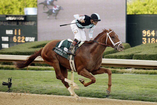Jockey Joe Bravo celebrates after riding Danza to win the Arkansas Derby horse race at Oaklawn Park in Hot Springs, Ark., Saturday, April 12, 2014. (AP Photo/Danny Johnston)
