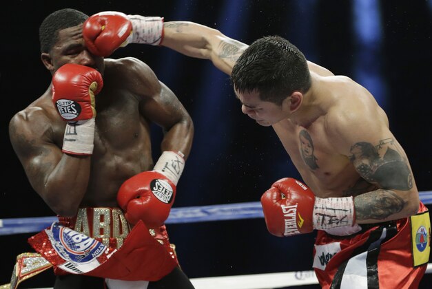 Marcos Rene Maidana, right, lands a punch on Adrien Broner, left, during an WBA welterweight title bout, Saturday, Dec. 14, 2013, in San Antonio. (AP Photo/Eric Gay)