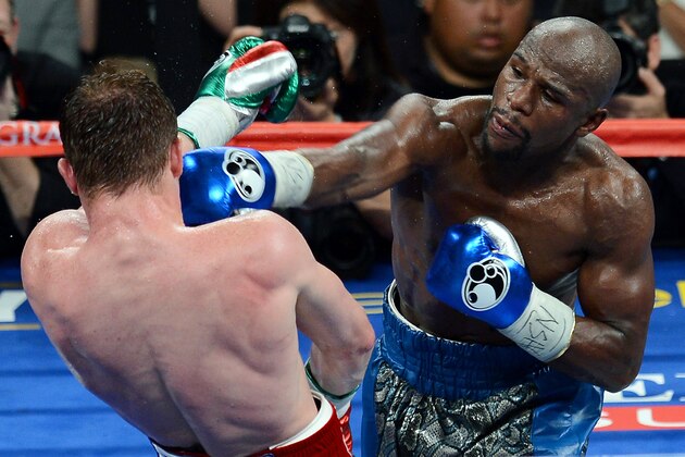 LAS VEGAS, NV - SEPTEMBER 14: Floyd Mayweather Jr. (R) hits Canelo Alvarez in the seventh round of their WBC/WBA 154-pound title fight at the MGM Grand Garden Arena on September 14, 2013 in Las Vegas, Nevada. Mayweather won by majority decision. (Photo by Ethan Miller/Getty Images) LAS VEGAS, NV - SEPTEMBER 14: Floyd Mayweather Jr. (R) hits Canelo Alvarez in the seventh round of their WBC/WBA 154-pound title fight at the MGM Grand Garden Arena on September 14, 2013 in Las Vegas, Nevada. Mayweather won by majority decision. (Photo by Ethan Miller/Getty Images)