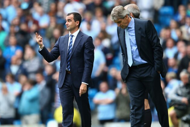 MANCHESTER, ENGLAND - OCTOBER 05:  Manuel Pellegrini (R) the manager of Manchester City alongside Roberto Martinez (L) the manager of Evertonon during the Barclays Premier League match between Manchester City and Everton at the Etihad Stadium on October 5, 2013 in Manchester, England.  (Photo by Michael Steele/Getty Images)
