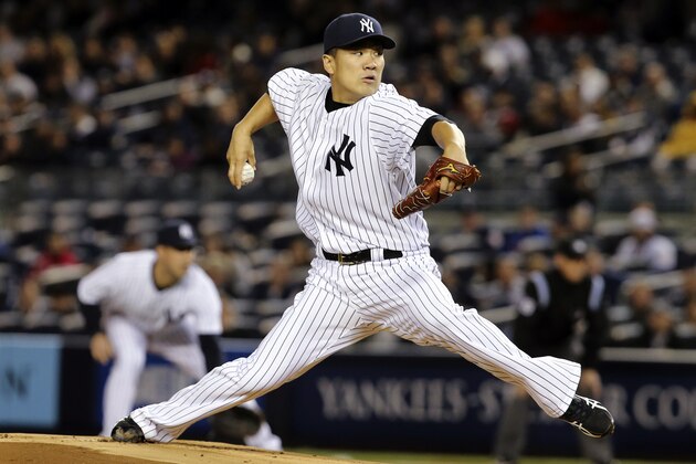 New York Yankees starting pitcher Masahiro Tanaka throws in the first inning of their baseball game against the Los Angeles Angels at Yankee Stadium, Sunday, April 27, 2014, in New York. (AP Photo/John Minchillo)