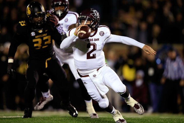 COLUMBIA, MO - NOVEMBER 30:  Quarterback Johnny Manziel #2 of the Texas A&M Aggies scrambles as defensive lineman Markus Golden #33 of the Missouri Tigers persues during the game on November 30, 2013 in Columbia, Missouri.  (Photo by Jamie Squire/Getty Images)
