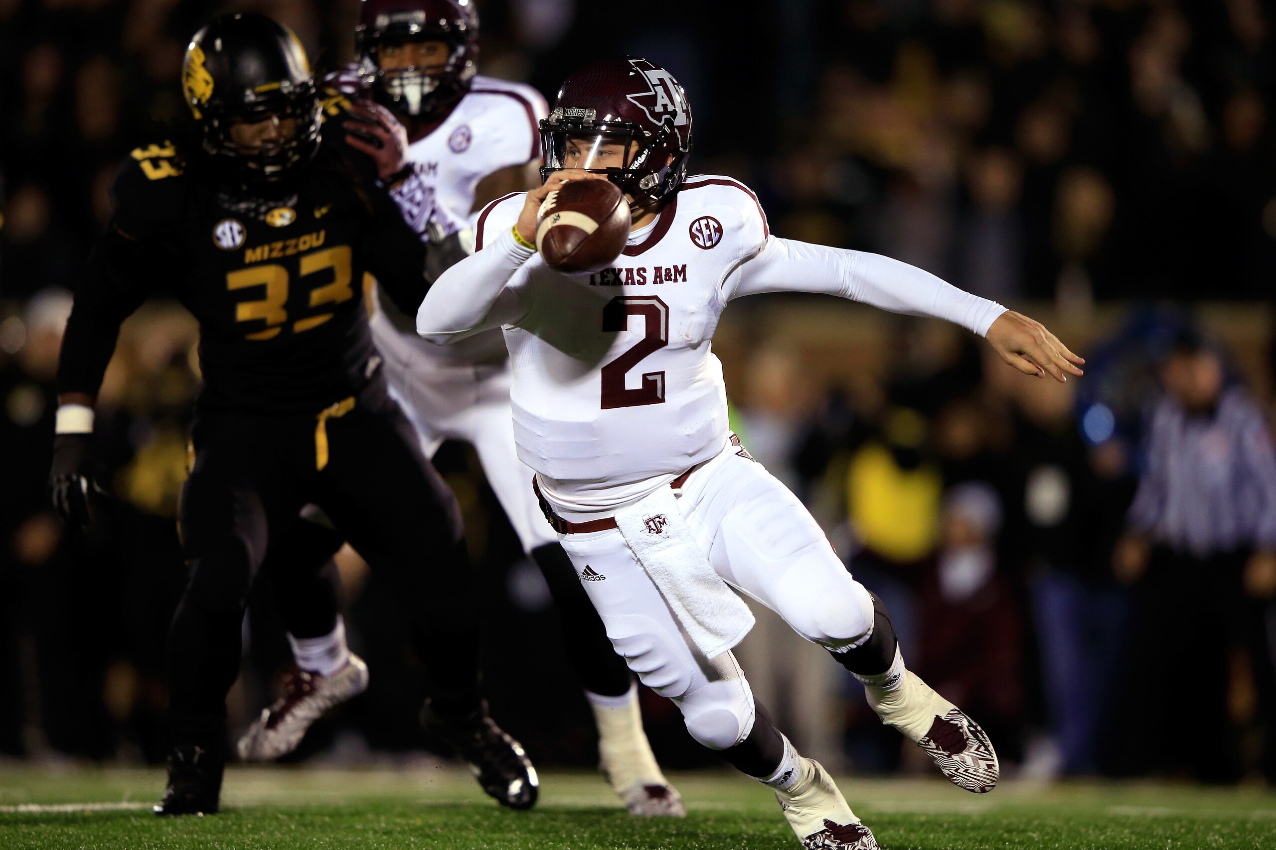 COLUMBIA, MO - NOVEMBER 30:  Quarterback Johnny Manziel #2 of the Texas A&M Aggies scrambles as defensive lineman Markus Golden #33 of the Missouri Tigers persues during the game on November 30, 2013 in Columbia, Missouri.  (Photo by Jamie Squire/Getty Images)