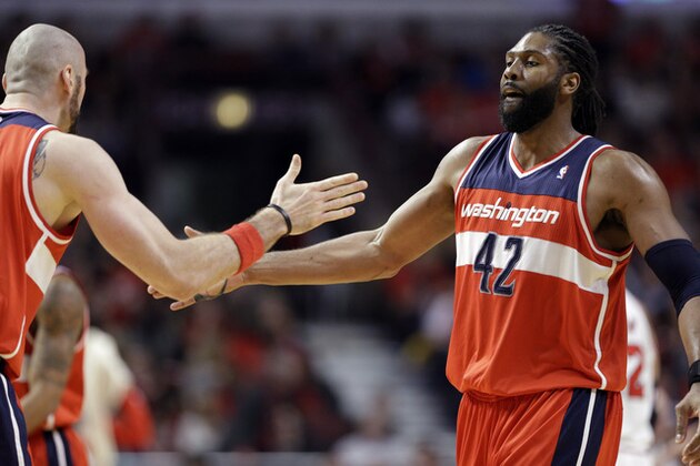 Washington Wizards forward Nene, right, celebrates with center Marcin Gortat after scoring  basket against the Chicago Bulls during the second half in Game 1 of an opening-round NBA basketball playoff series in Chicago, Sunday, April 20, 2014. The Wizards won 102-93. (AP Photo/Nam Y. Huh)