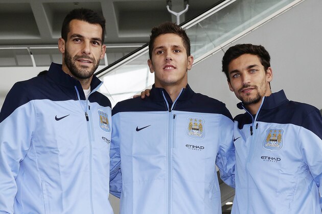 HONG KONG - JULY 22: (L-R) Newly signed Manchester City players  Alvaro Negredo, Stevan Jovetic and Jesus Navas pose for a  photo at Hong Kong Airport as they arrive to compete in the Barclays Asia Trophy, on July 22, 2013 in Hong Kong.  (Photo by Jessica Hromas/Getty Images)