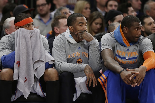 New York Knicks' Carmelo Anthony, left, J.R. Smith, center, and Amar'e Stoudemire, right, watch their team play during the first half of an NBA basketball game against the Philadelphia 76ers Monday, March 10, 2014, in New York. (AP Photo/Frank Franklin II)