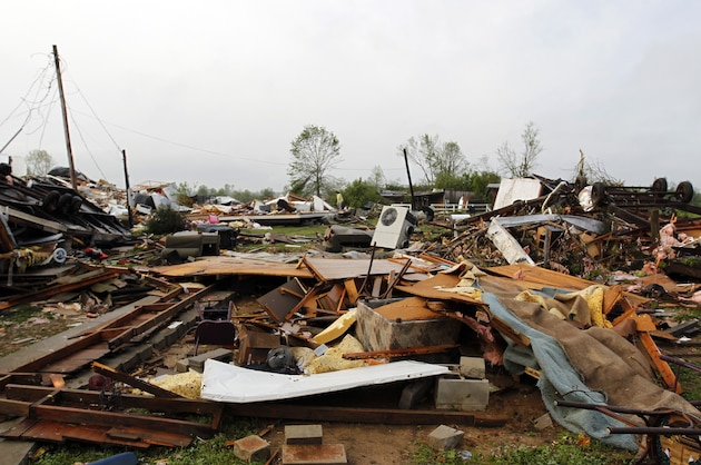 Residents sift through the debris after a tornado passed through destroying Billy Barbs mobile home park on Tuesday, April 29, 2014, in Athens, Ala.  A dangerous storm system that spawned a chain of deadly tornadoes over three days flattened homes and businesses, forced frightened residents in more than half a dozen states to take cover and left tens of thousands in the dark Tuesday morning.(AP Photo/Butch Dill)