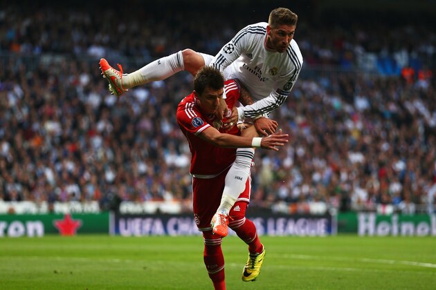 MADRID, SPAIN - APRIL 23:  Sergio Ramos of Real Madrid climbs on Mario Mandzukic of Bayern Muenchen during the UEFA Champions League semi-final first leg match between Real Madrid and FC Bayern Muenchen at the Estadio Santiago Bernabeu on April 23, 2014 in Madrid, Spain.  (Photo by Paul Gilham/Getty Images)