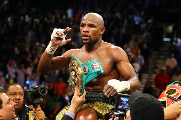 LAS VEGAS, NV - MAY 04:  Floyd Mayweather Jr. celebrates his unanimous decision victory against Robert Guerrero in their WBC welterweight title bout at the MGM Grand Garden Arena on May 4, 2013 in Las Vegas, Nevada.  (Photo by Al Bello/Getty Images)