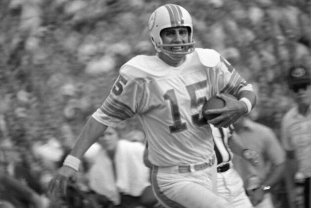 Miami Dolphins quarterback Earl Morrall (15) with his receivers covered in the second half, Morrall scoots across the goal for a Dolphin score as Miami went on to down the New York Jets, 28-24, for their 11th win of the season against no losses.  (AP Photo/Steve Starr )