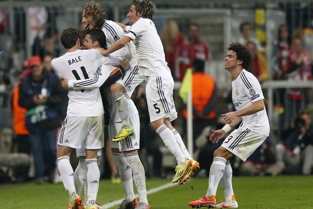 Real's Cristiano Ronaldo, second left, celebrates scoring his side's 4th goal during the Champions League semifinal second leg soccer match between Bayern Munich and Real Madrid at the Allianz Arena in Munich, southern Germany, Tuesday, April 29, 2014. (AP Photo/Matthias Schrader)