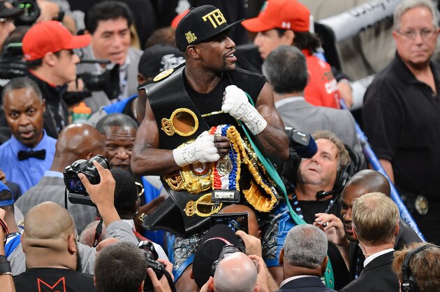 LAS VEGAS, NV - SEPTEMBER 14:  Floyd Mayweather Jr. celebrates his majority-decision victory over Canelo Alvarez in their WBC/WBA 154-pound title fight at the MGM Grand Garden Arena on September 14, 2013 in Las Vegas, Nevada.  (Photo by Ethan Miller/Getty Images)