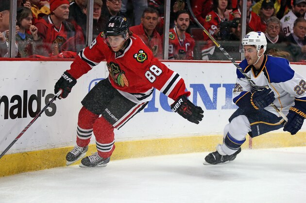 CHICAGO, IL - APRIL 27: Patrick Kane #88 of the Chicago Blackhawks moves around the corner trailed by Kevin Shattenkirk #22 of the St. Louis Blues in Game Six of the First Round of the 2014 NHL Stanley Cup Playoffs at the United Center on April 27, 2014  in Chicago, Illinois. The Blackhawks defeated the Blues 5-1 to win the series four games to two. (Photo by Jonathan Daniel/Getty Images)