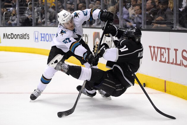 San Jose Sharks center Tommy Wingels, left, pushes down Los Angeles Kings center Anze Kopitar, of Slovenia, during the third period in Game 6 of an NHL hockey first-round playoff series, Monday, April 28, 2014, in Los Angeles. The Kings won 4-1. (AP Photo)