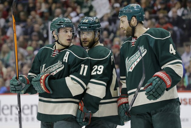 Minnesota Wild left wing Zach Parise (11) talks with right wing Jason Pominville (29) and defenseman Clayton Stoner (4) before a face-off during the second period of Game 6 of an NHL hockey first-round playoff series against the Colorado Avalanche in St. Paul, Minn., Monday, April 28, 2014. (AP Photo/Ann Heisenfelt)
