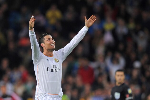 MADRID, SPAIN - APRIL 26:  Cristiano Ronaldo of Real Madrid CF celebrates after scoring Real's 2nd goal from a free kick during the La Liga match between Real Madrid CF and CA Osasuna at the Santiago Bernabeu stadium on April 26, 2014 in Madrid, Spain.  (Photo by Denis Doyle/Getty Images)