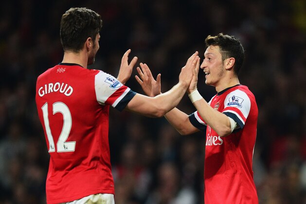 LONDON, ENGLAND - APRIL 28:  Mesut Oezil of Arsenal (11) celebrates with Olivier Giroud as he scores their second goal during the Barclays Premier League match between Arsenal and Newcastle United at Emirates Stadium on April 28, 2014 in London, England.  (Photo by Jamie McDonald/Getty Images)