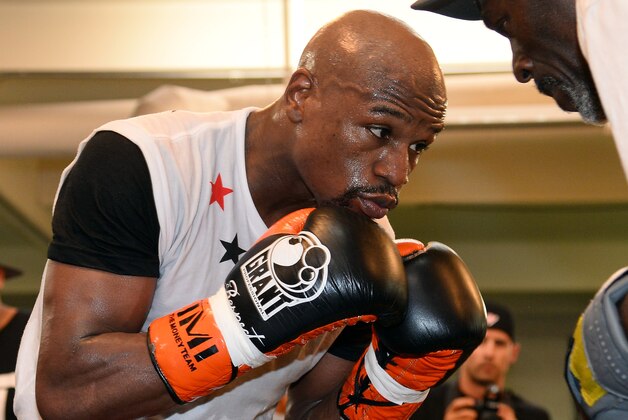 LAS VEGAS, NV - APRIL 22:  Boxer Floyd Mayweather Jr. works out with his trainer and uncle Roger Mayweather at the Mayweather Boxing Club on April 22, 2014 in Las Vegas, Nevada. Mayweather will face Marcos Maidana in a 12-round world championship unification bout in Las Vegas on May 3.  (Photo by Ethan Miller/Getty Images)