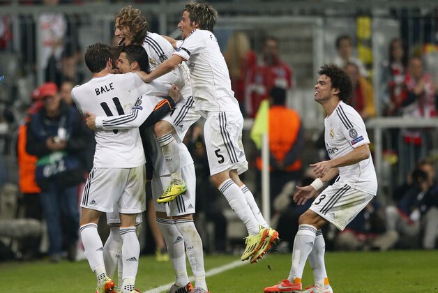 Real's Cristiano Ronaldo, second left, celebrates scoring his side's 4th goal during the Champions League semifinal second leg soccer match between Bayern Munich and Real Madrid at the Allianz Arena in Munich, southern Germany, Tuesday, April 29, 2014. (AP Photo/Matthias Schrader)
