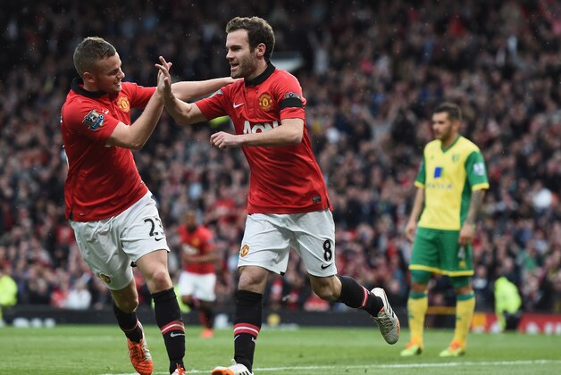 MANCHESTER, ENGLAND - APRIL 26:  Juan Mata of Manchester United celebrates scoring the third goal with Tom Cleverley during the Barclays Premier League match between Manchester United and Norwich City at Old Trafford on April 26, 2014 in Manchester, England.  (Photo by Laurence Griffiths/Getty Images)