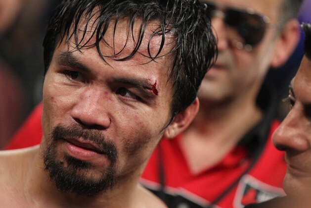 Manny Pacquiao stands in the ring following his victory over Timothy Bradley in their WBO welterweight title boxing fight Saturday, April 12, 2014, in Las Vegas. (AP Photo/Isaac Brekken)