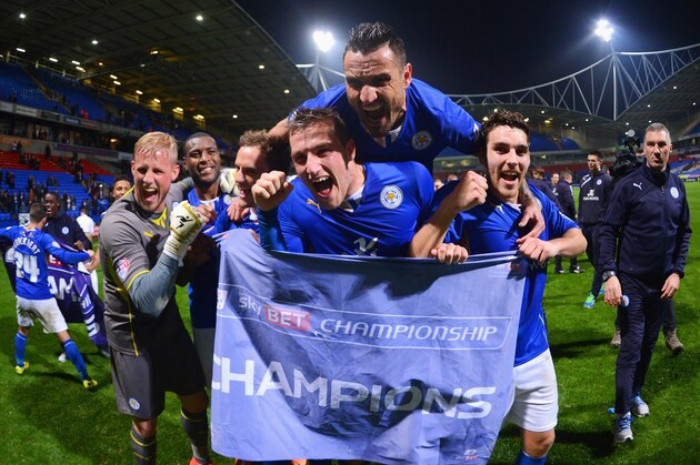 BOLTON, ENGLAND - APRIL 22: Marcin Wasilewski (top), Chris Wood and Matty James (R) of Leicester City celebrate winning the Championship with goalkeeper Kasper Schmeichel (L) after the Sky Bet Championship match between Bolton Wanderers and Leicester City at Reebok Stadium on April 22, 2014 in Bolton, England.  (Photo by Michael Regan/Getty Images)