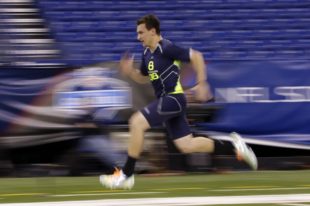 Texas A&M quarterback Johnny Manziel runs the 40-yard dash at the NFL football scouting combine in Indianapolis, Sunday, Feb. 23, 2014. (AP Photo/Michael Conroy)