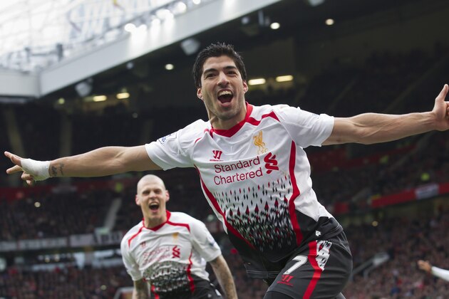 Liverpool's Luis Suarez celebrates after scoring against Manchester United, during their English Premier League soccer match at Old Trafford Stadium, Manchester, England, Sunday, March 16, 2014. (AP Photo/Jon Super)