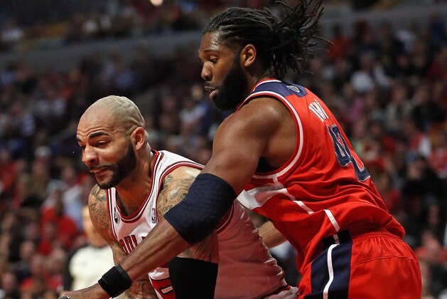 CHICAGO, IL - APRIL 29: Carlos Boozer #5 of the Chicago Bulls tries to move against Nene #42 of the Washington Wizards in Game Five of the Eastern Conference Quarterfinals during the 2014 NBA Playoffs at the United Center on April 29, 2014 in Chicago, Illinois. The Wizards defeated the Bulls 75-69 to win the series four games to one. NOTE TO USER: User expressly acknowledges and agrees that, by downloading and or using this photograph, User is consenting to the terms and conditions of the Getty Images License Agreement. (Photo by Jonathan Daniel/Getty Images)