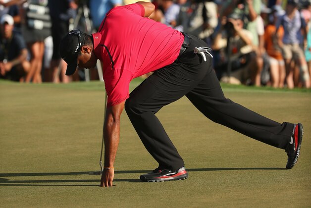 DORAL, FL - MARCH 09:  Tiger Woods collects his golf ball during the final round of the World Golf Championships-Cadillac Championship at Trump National Doral on March 9, 2014 in Doral, Florida.  (Photo by Mike Ehrmann/Getty Images)