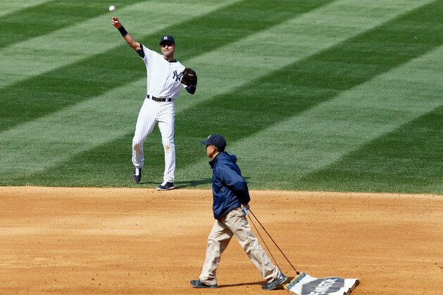 NEW YORK, NY - APRIL 26:  Derek Jeter #2 of the New York Yankees warms up as the grounds crew works the field in the seventh inning against the Los Angeles Angels of Anaheim on April 26, 2014 at Yankee Stadium in the Bronx borough of New York City.  (Photo by Elsa/Getty Images)