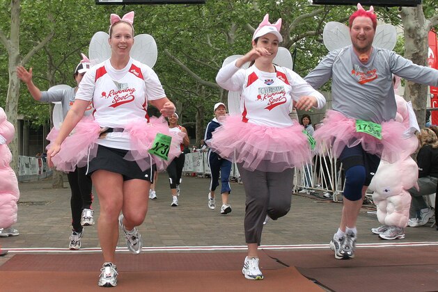 Runners in costume cross the finish line of the 26.2 mile Flying Pig Marathon race in Cincinnati, Sunday, May 7, 2006. (AP Photo/Tom Uhlman)