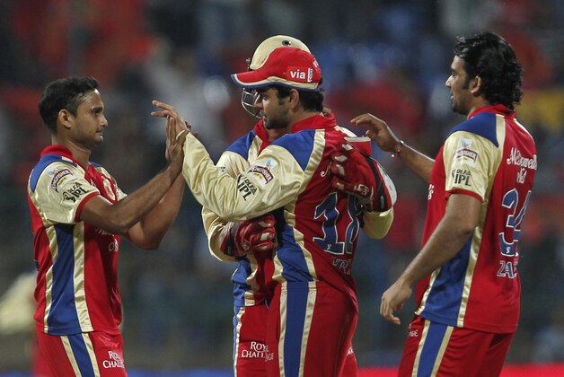 Royal Challengers Bangalore Skipper Virat Kohli, second right, celebrates the wicket of Deccan Chargers' Daniel Harris during an Indian Premier League (IPL) cricket match in Bangalore, India, Sunday, May 6, 2012. (AP Photo)