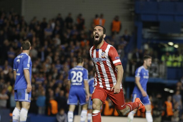 Atletico's Arda Turan celebrates after scoring his soda's 3rd goal during the Champions League semifinal second leg soccer match between Chelsea and Atletico Madrid at Stamford Bridge Stadium in London Wednesday, April 30, 2014. (AP Photo/Kirsty Wigglesworth)