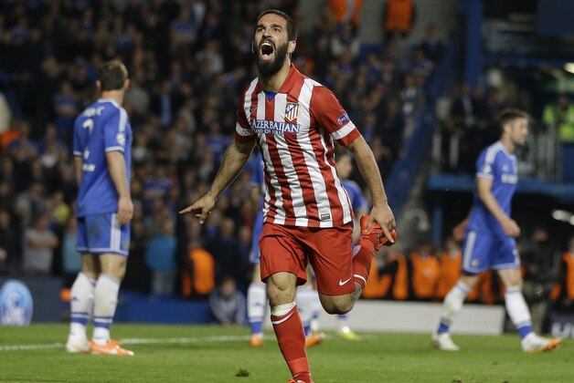 Atletico's Arda Turan celebrates after scoring his soda's 3rd goal during the Champions League semifinal second leg soccer match between Chelsea and Atletico Madrid at Stamford Bridge Stadium in London Wednesday, April 30, 2014. (AP Photo/Kirsty Wigglesworth)