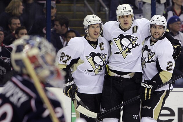 Pittsburgh Penguins' Sidney Crosby, left, Evgeni Malkin, center, of Russia, and Matt Niskanen celebrate Malkin's goal against the Columbus Blue Jackets during the first period of Game 6 of a first-round NHL playoff hockey series Monday, April 28, 2014, in Columbus, Ohio. (AP Photo/Jay LaPrete)