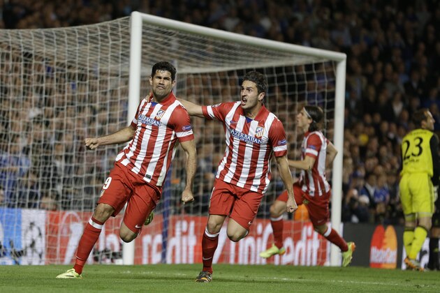 Atletico's Diego Costa, left celebrates with  Koke after he scored a penalty during the Champions League semifinal second leg soccer match between Chelsea and Atletico Madrid at Stamford Bridge Stadium in London Wednesday, April 30, 2014. (AP Photo/Kirsty Wigglesworth)