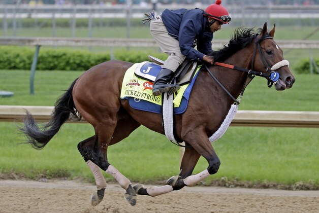 Exercise rider Kelvin Pahal takes Kentucky Derby hopeful Wicked Strong for a morning workout at Churchill Downs Wednesday, April 30, 2014, in Louisville, Ky. (AP Photo/Morry Gash)