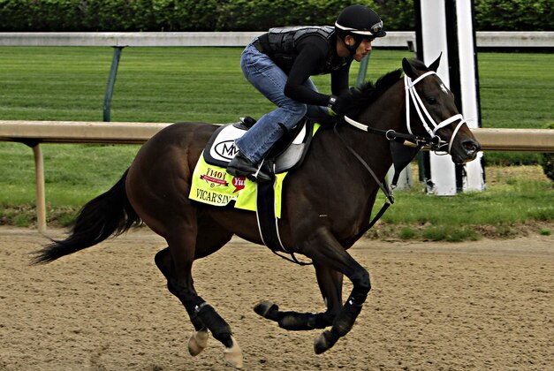 Kentucky Derby hopeful Vicar's In Trouble, ridden by exercise rider Joel Barrientos, gallops on the track at Churchill Downs in Louisville, Ky., Friday, April 25, 2014.  (AP Photo/Garry Jones)