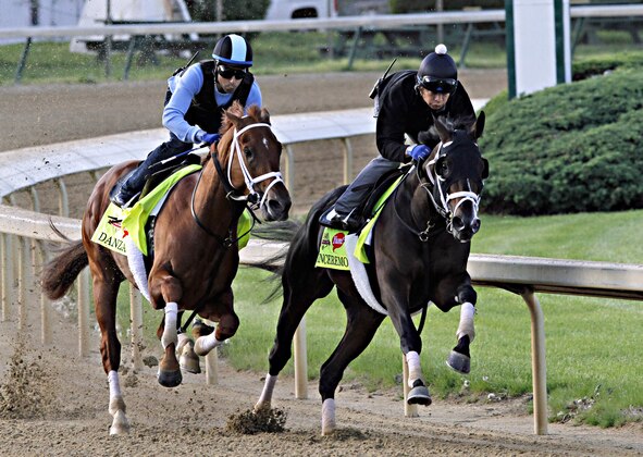 Kentucky Derby hopefuls Danza, left, ridden by Ezequiel Perez, and stablemate Vinceremos, ridden by exercise rider Ovel Merida, work in company for trainer Todd Pletcher at Churchill Downs in Louisville, Ky., Sunday, April 27, 2014. (AP Photo/Garry Jones) Kentucky Derby hopefuls Danza, left, ridden by Ezequiel Perez, and stablemate Vinceremos, ridden by exercise rider Ovel Merida, work in company for trainer Todd Pletcher at Churchill Downs in Louisville, Ky., Sunday, April 27, 2014. (AP Photo/Garry Jones)
