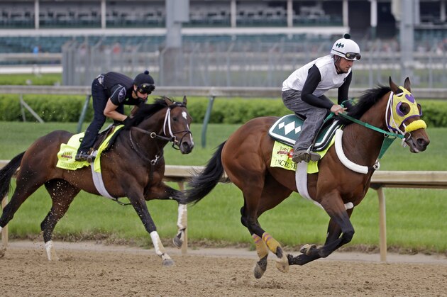 Exercise rider Benito Alvarado on Kentucky Derby hopeful Uncle Sigh and Exercise rider Emerson Chavez on Kentucky Derby hopeful Commanding Curve go for a morning workout at Churchill Downs Wednesday, April 30, 2014, in Louisville, Ky. (AP Photo/Morry Gash)