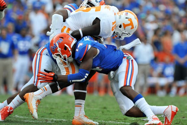 GAINESVILLE, FL - SEPTEMBER 21: Defensive back Jaylen Watkins #14 of the Florida Gators tackles running back Marlin Lane #15 of  the Tennessee Volunteers  September 21, 2013 at Ben Hill Griffin Stadium at Florida Field in Gainesville, Florida.  (Photo by Al Messerschmidt/Getty Images)
