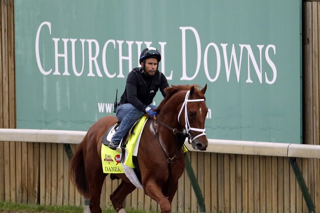 Exercise rider Ezequiel Perez takes Kentucky Derby hopeful Danza for a morning workout at Churchill Downs Wednesday, April 30, 2014, in Louisville, Ky. (AP Photo/Charlie Riedel)