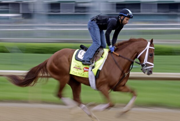 Exercise rider Ezequiel Perez takes Kentucky Derby hopeful Danza for a morning workout at Churchill Downs Wednesday, April 30, 2014, in Louisville, Ky. (AP Photo/Morry Gash)